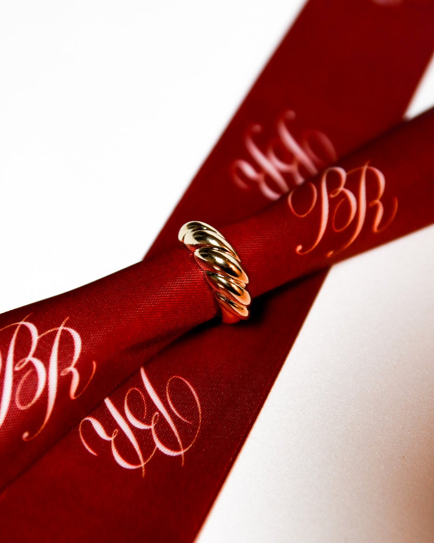18k gold filled croissant statement ring styled on luxury red Bre’ella Rose & Co ribbon