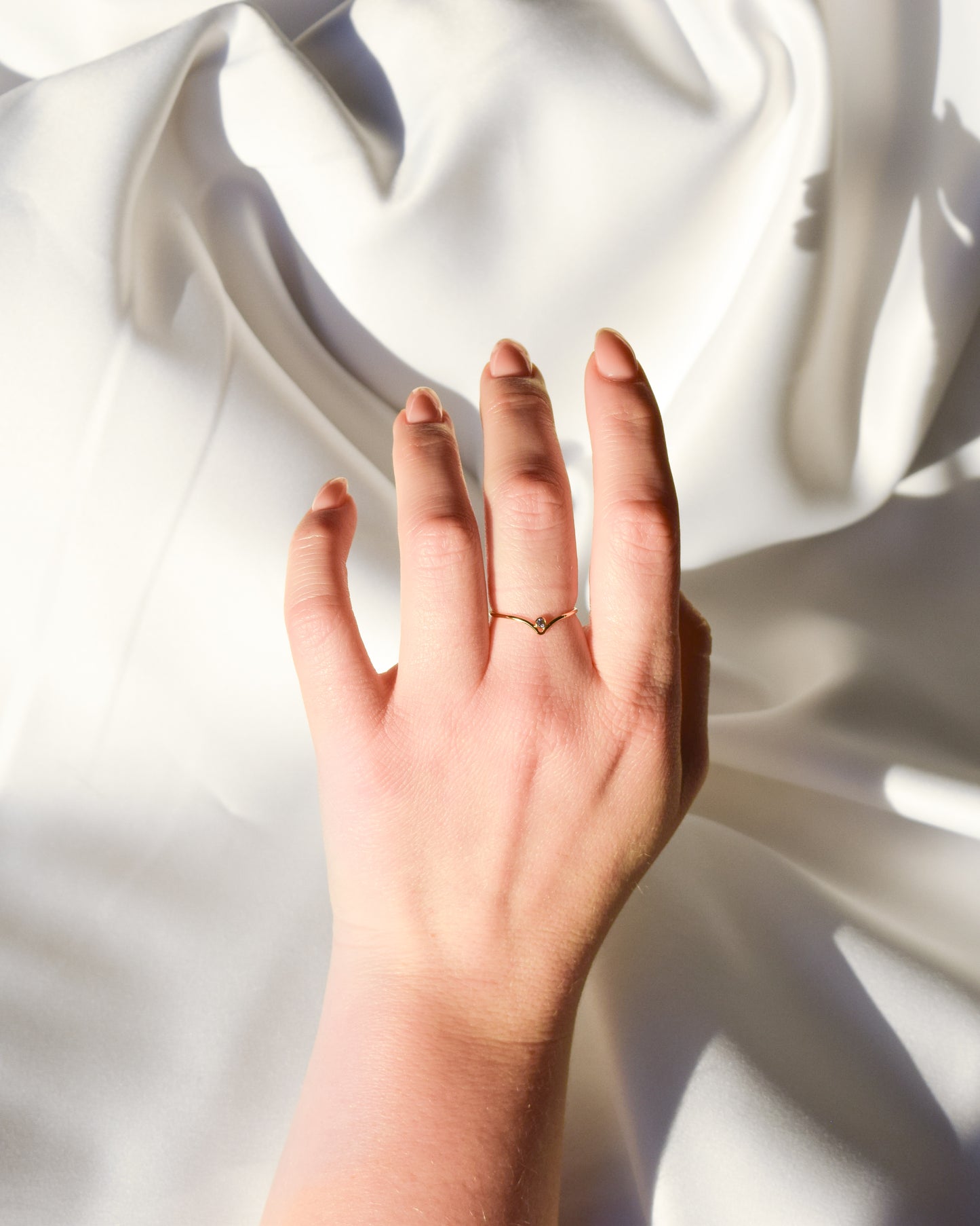 14k gold filled chevron stacking ring with cubic zirconia worn on hand in natural light